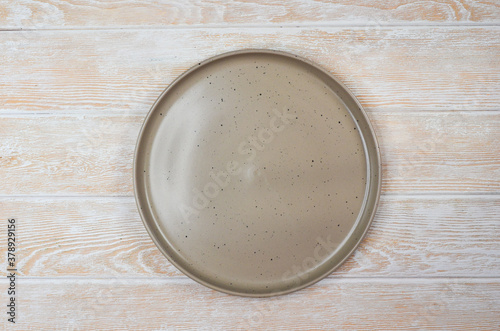 empty grey ceramic plate top view, space for text or design, food concept