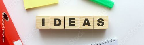 Wooden cubes with word IDEAS on the office desk.