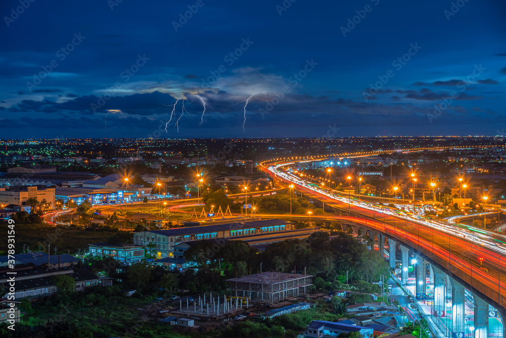 Samutprakarn cityscape. View of main highway with lightning on the sky at night at Samutprakarn in Thailand.
