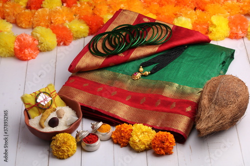 oti bharne - Indian ritual of offering a sari and a blouse piece along with coconut, haldi kumkum, bangles, mangalsutra and rice. At the time of navratri to goddes or married woman. photo