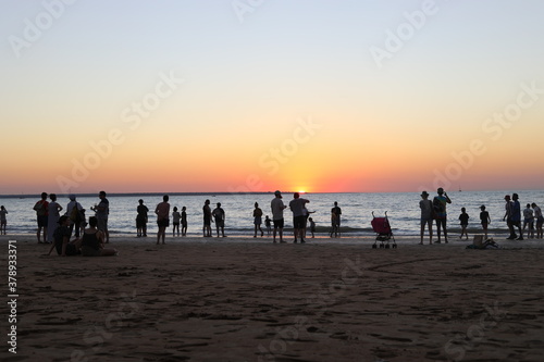 people on the beach at sunset