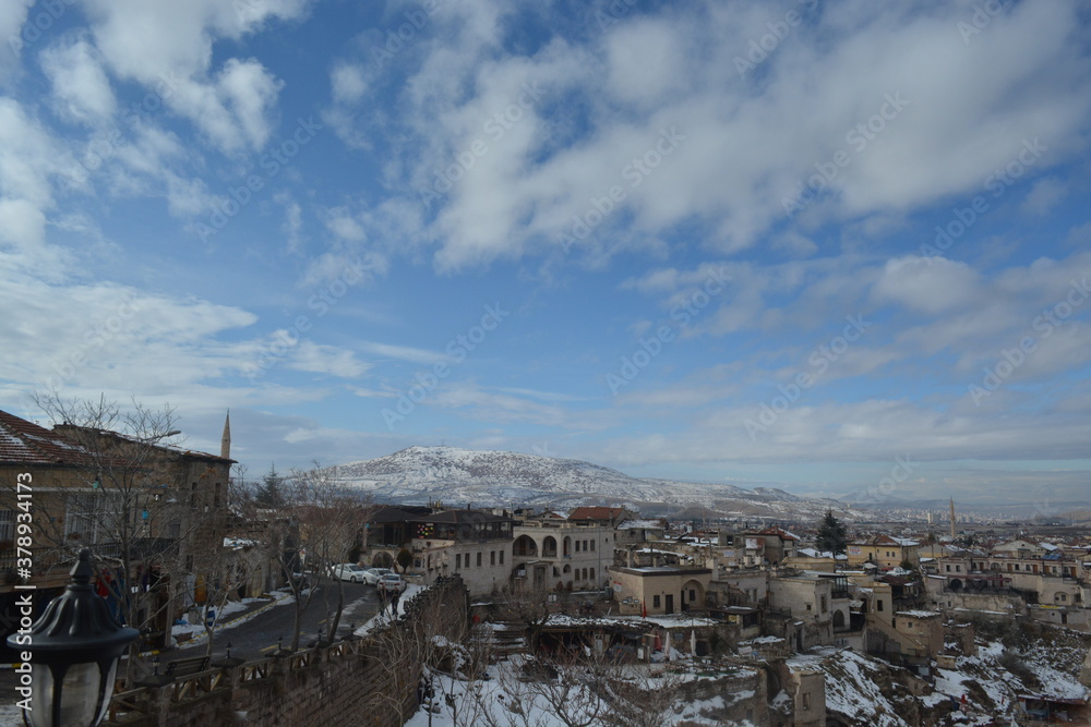 Historical caves, snowy mountains, fairy chimneys and settlements in Cappadocia.