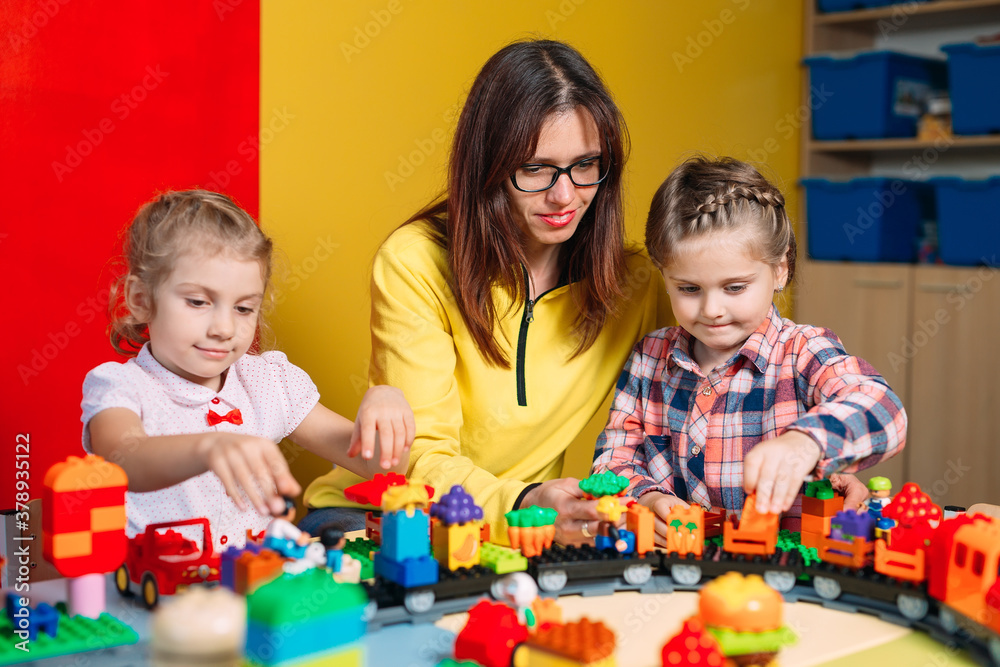 Educational toys for preschool and kindergarten child. Child playing with constructor blocks at class. Educational toys for preschool and kindergarten child. Child playing with constructor blocks at class.