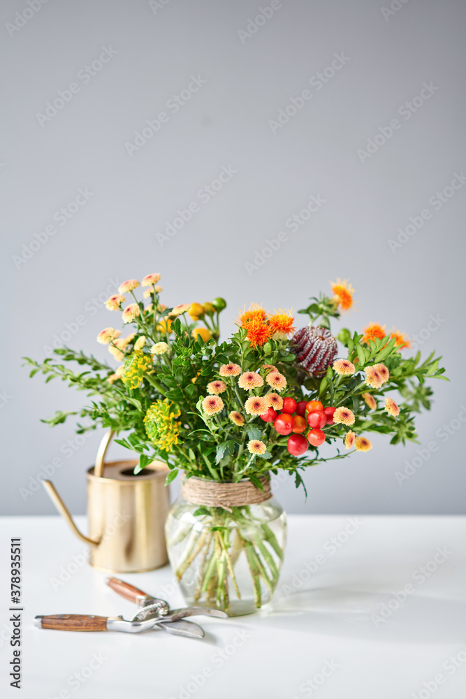 Fototapeta premium Series, step by step installation of flowers in a vase. Flowers bunch, set for home. Fresh cut flowers for decoration home. European floral shop. Delivery fresh cut flower.