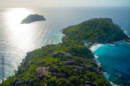 Aerial view of a tropical island with coastline and blue ocean. Félicité Island, La Digue, Seychelles