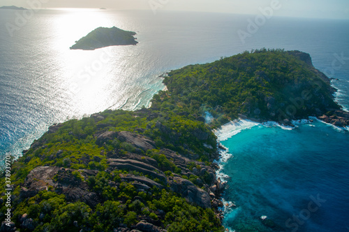 Aerial view of a tropical island with coastline and blue ocean. Félicité Island, La Digue, Seychelles