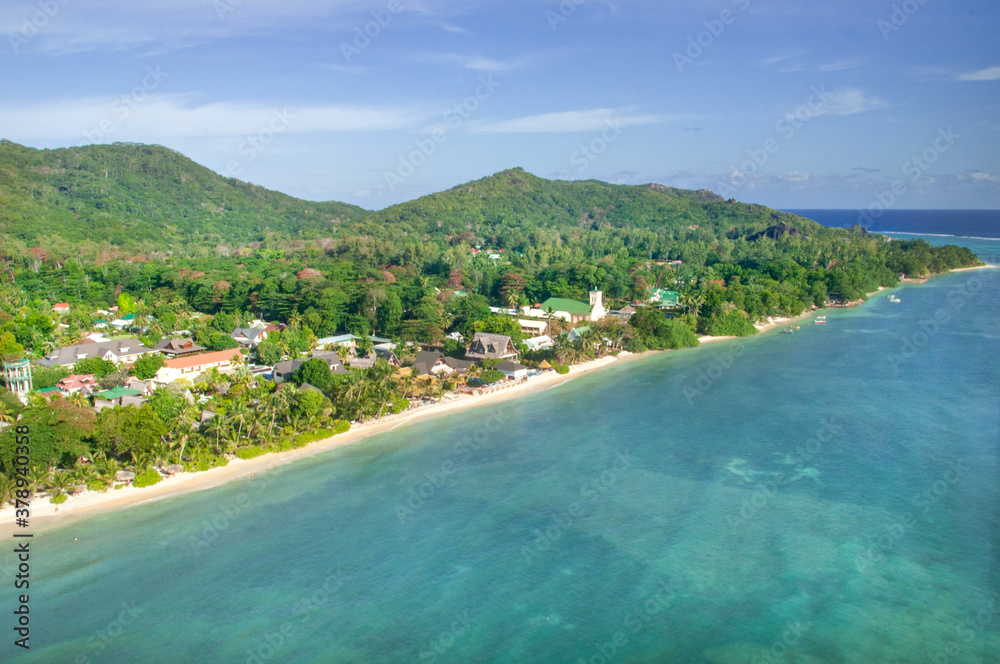 Aerial view of a tropical island with coastline and blue ocean. La Digue Island, Seychelles