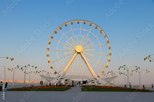 Ferris wheel on the background of blue sky. Boulevard National Park of Baku. © Nurlan