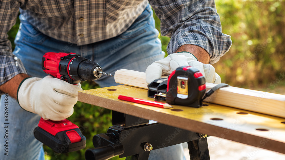 Carpenter at work on wooden boards. Carpentry.