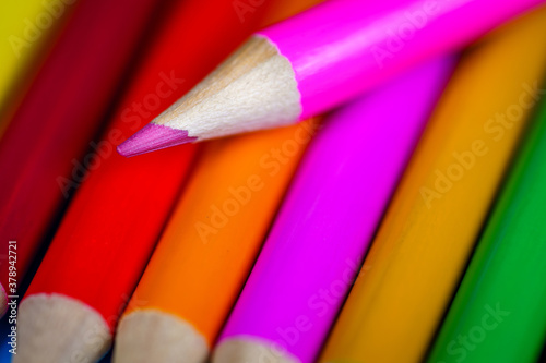 Heap of colorful pencils with blurred background. Close up photo