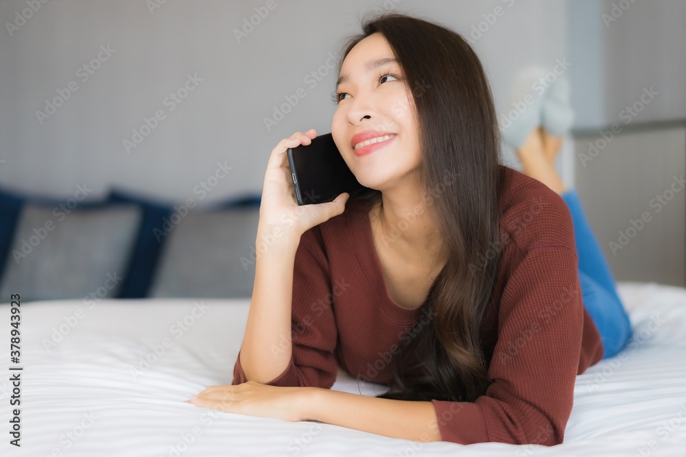 Portrait beautiful young asian woman use smart mobile phone on bed Portrait beautiful young asian woman use smart mobile phone on bed