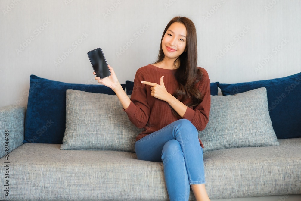 Portrait beautiful young asian woman use smart phone on sofa Portrait beautiful young asian woman use smart phone on sofa