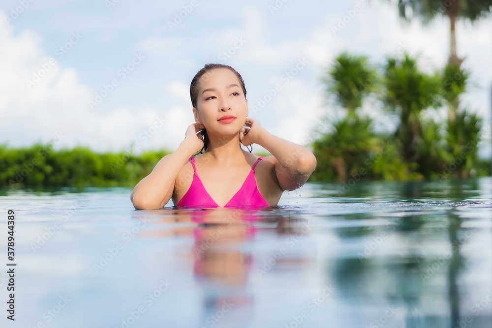 Portrait beautiful young asian woman relax enjoy around outdoor swimming pool
