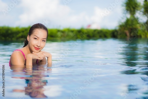 Portrait beautiful young asian woman relax enjoy around outdoor swimming pool © siraphol