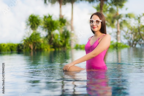 Portrait beautiful young asian woman relax enjoy around outdoor swimming pool © siraphol