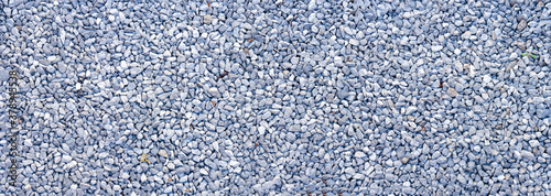 small road stone panorama background. dark gravel pebbles background