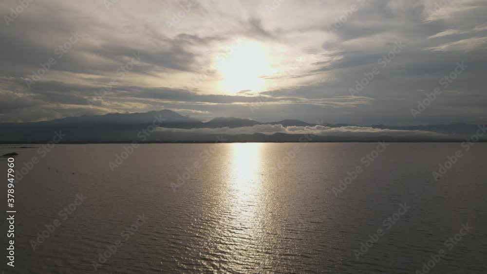 Scenic Sunset Reflection on River on Water Surface. Evening Countryside Rural Scenery. Rainy Clouds Weather Spring season Scenic Sunset Reflection on River on Water Surface. Evening Countryside Rural Scenery. Rainy Clouds Weather Spring season