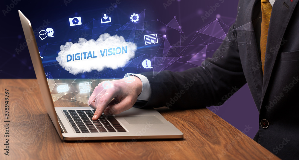 Businessman working on laptop with DIGITAL VISION inscription, modern technology concept Businessman working on laptop with DIGITAL VISION inscription, modern technology concept