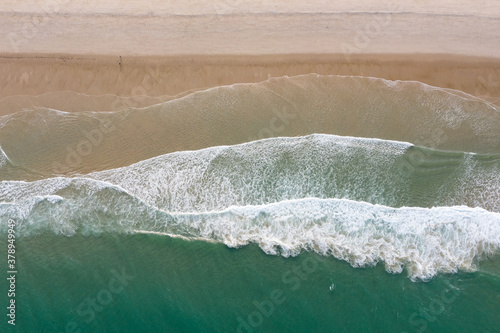 The Atlantic Ocean washes onto a scenic, sandy beach on Cape Cod, Massachusetts. This scenic peninsula is a popular summer vacation destination in New England.