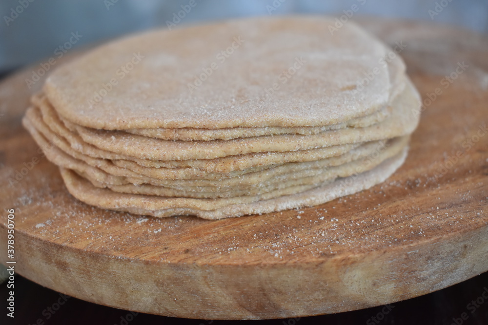 stack of rolled wheat flour flat bread base or poori base indian cuisine