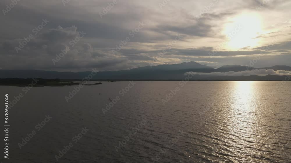 Scenic Sunset Reflection on River on Water Surface. Evening Countryside Rural Scenery. Rainy Clouds Weather Spring season Scenic Sunset Reflection on River on Water Surface. Evening Countryside Rural Scenery. Rainy Clouds Weather Spring season