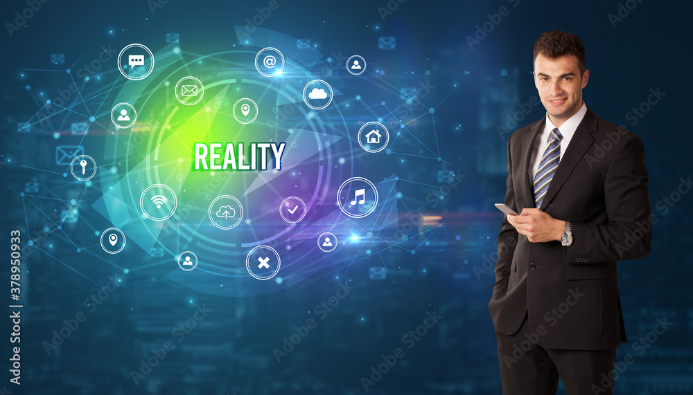 Businessman thinking in front of technology related icons and REALITY inscription, modern technology concept Businessman thinking in front of technology related icons and REALITY inscription, modern technology concept