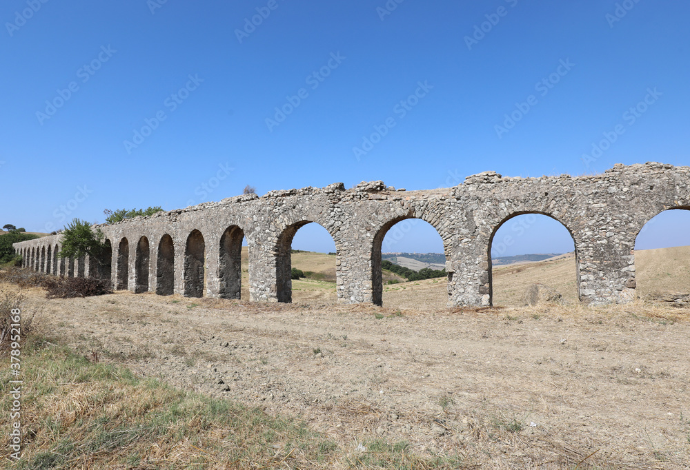 ancient aqueduct made with stones and arches to bring water to t