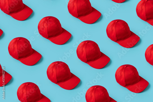 Knolling Red Hats directly lined up on Blue Background from above