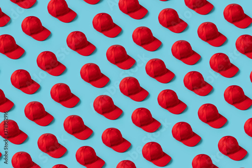 Many Small Knolling Red Hats on Blue Background from above