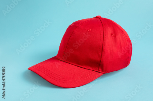 Fototapeta Red Baseball Cap on blue background