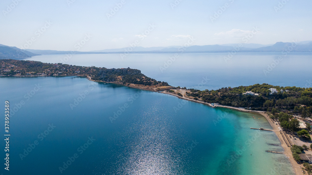 Aerial view on turqouise blue water and sandy beach of Limni Vouliagmeni or Ireon Lake, Peloponnese, Greece Aerial view on turqouise blue water and sandy beach of Limni Vouliagmeni or Ireon Lake, Peloponnese, Greece