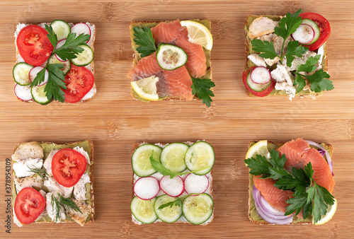 Set of sandwiches on a wooden background.
