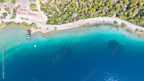 Aerial view on turqouise blue water and sandy beach of Limni Vouliagmeni or Ireon Lake, Peloponnese, Greece 