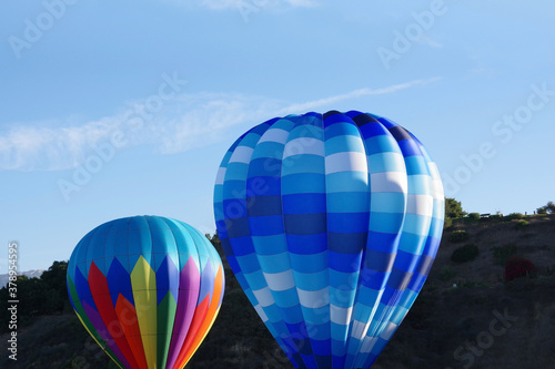 Two hot air balloons moments before lift-up into the early morning sky