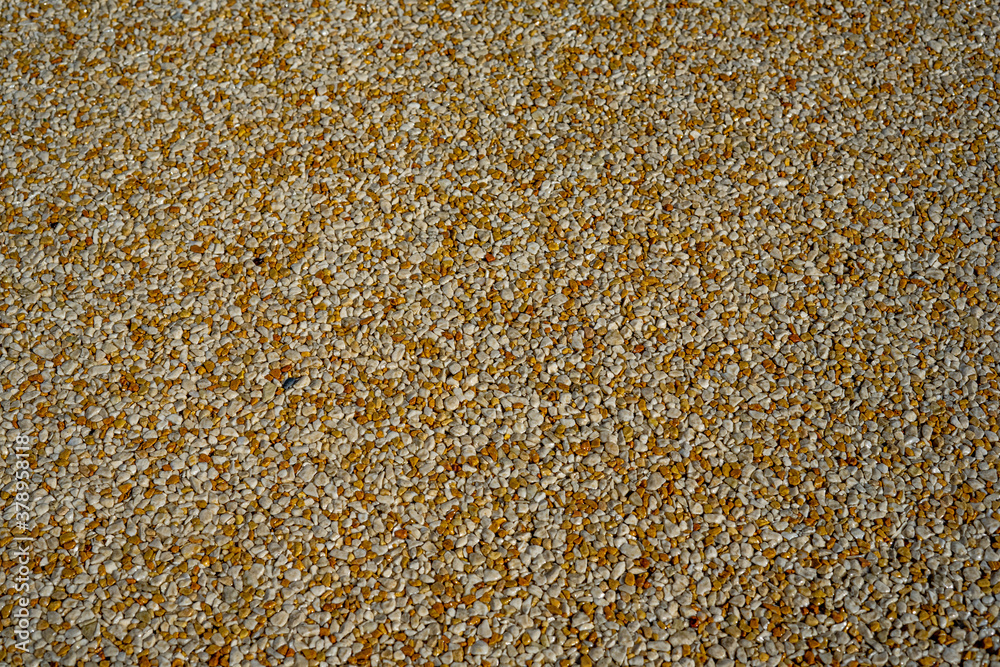 Tiny gravel texture on brown concrete wall. Texture background seamless gravel floor. Tiny gravel texture on brown concrete wall. Texture background seamless gravel floor.