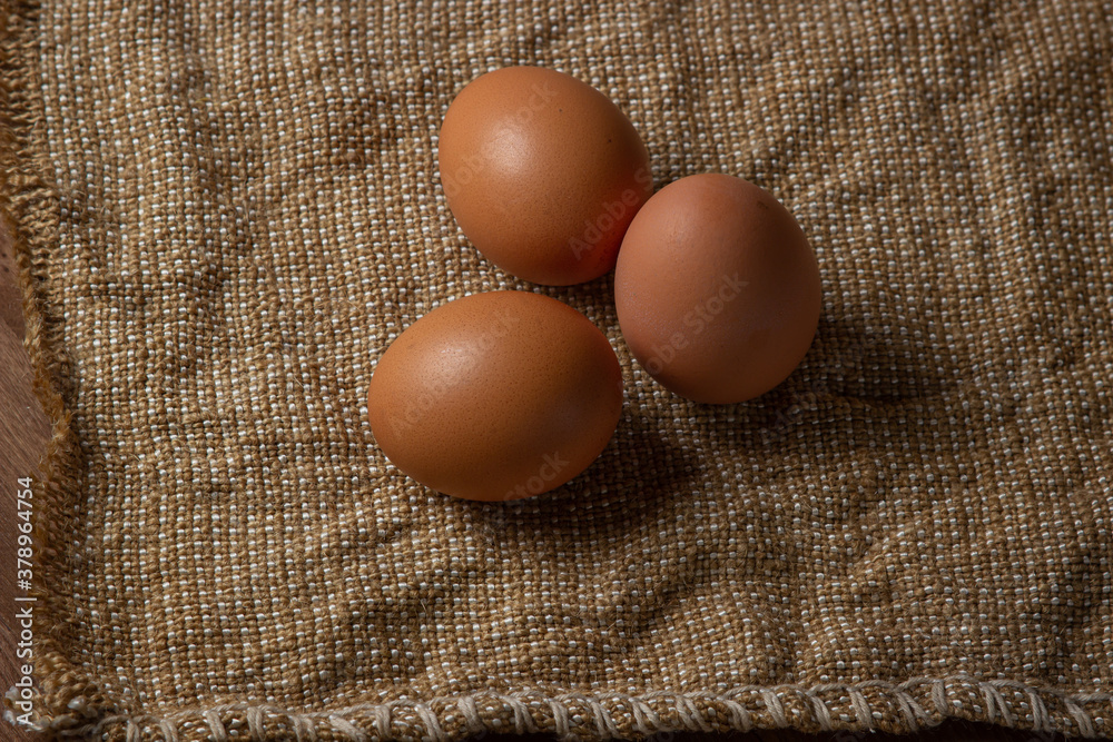 The eggs are on the sacking. Brown chicken eggs. The eggs are on the sacking. Brown chicken eggs.