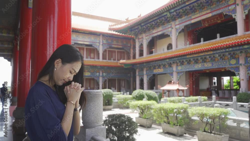 Beautiful Asian women make a wish in a Chinese temple.
Beautiful Asian women make a wish in a Chinese temple.
