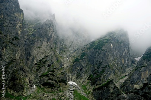  The peaks of the High Tatras with white clouds. Mountains in the clouds. High Tatras Mountains in Slovakia