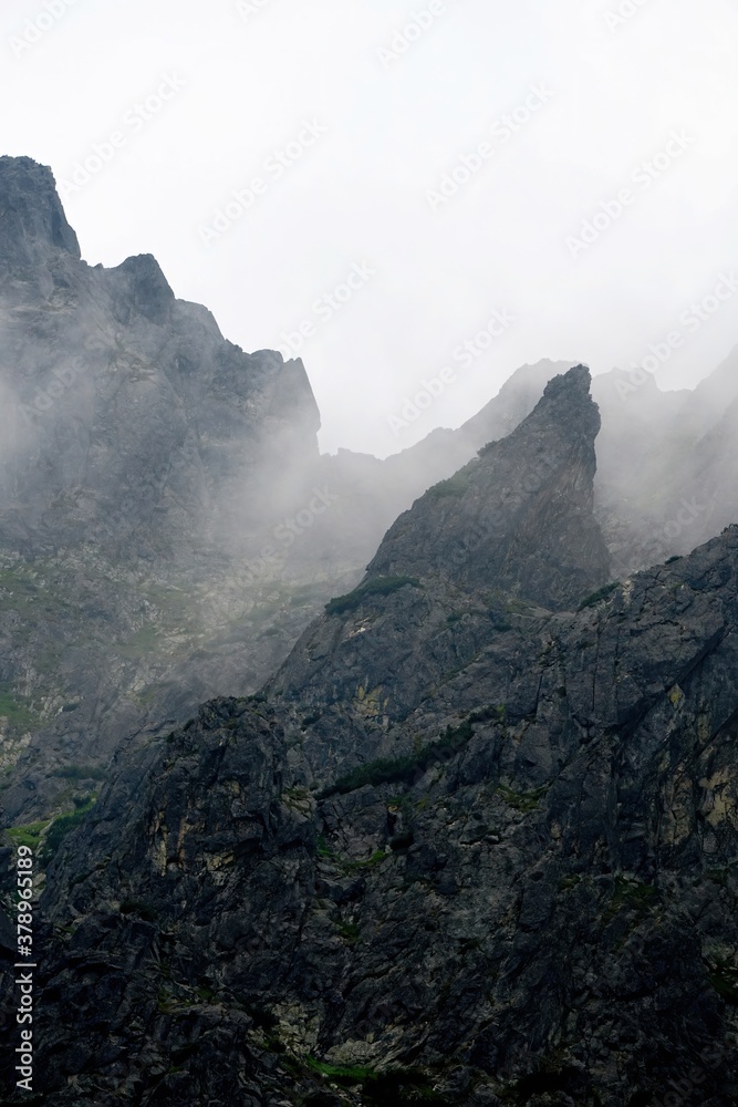 The peaks of the High Tatras with white clouds. Mountains in the clouds. High Tatras Mountains in Slovakia
The peaks of the High Tatras with white clouds. Mountains in the clouds. High Tatras Mountains in Slovakia