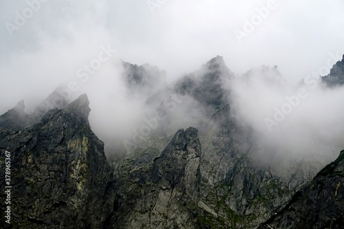  The peaks of the High Tatras with white clouds. Mountains in the clouds. High Tatras Mountains in Slovakia