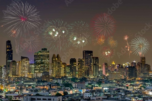 Colorful Fireworks above Bangkok City Cityscape Celebrating , A night long exposure of New Years Eve Celebration. © Patiwat