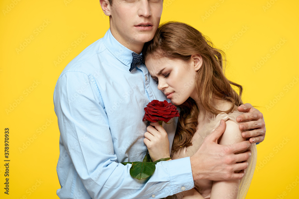 romantic couple in love with red flower hugging each other cropped view Copy Space romantic couple in love with red flower hugging each other cropped view Copy Space