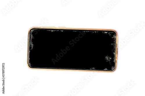A black smartphone with a broken screen on a white background