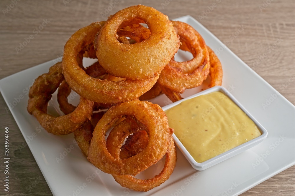 Crispy, beer battered onion rings, with Sriracha ranch & honey mustard. Crispy, beer battered onion rings, with Sriracha ranch & honey mustard.