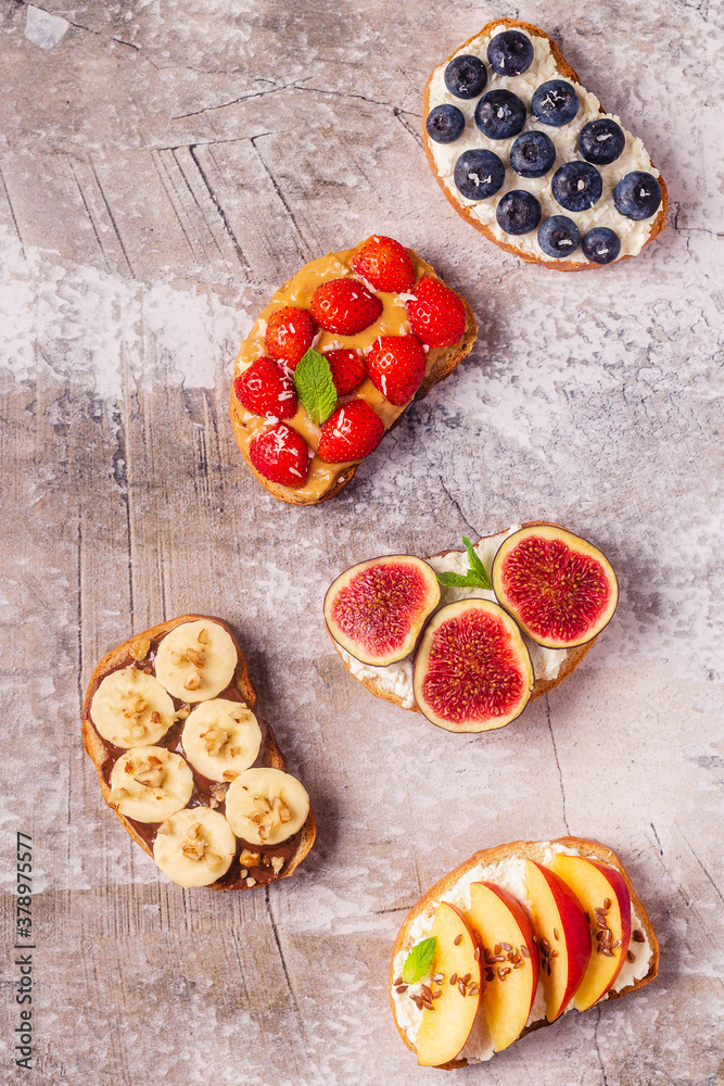 Homemade summer toast with cream cheese, nut butter and fruits and berries Homemade summer toast with cream cheese, nut butter and fruits and berries