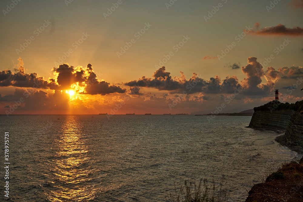 sunset by the sea, trees and lighthouse sunset by the sea, trees and lighthouse