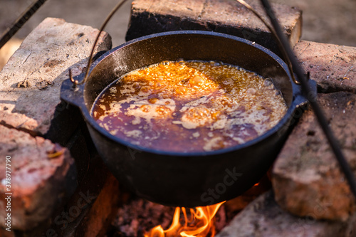 Preparation of pilaf in a cauldron on an open fire