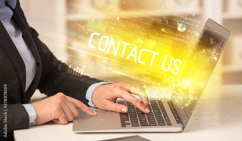 Closeup of businessman hands working on laptop with CONTACT US inscription, succesfull business concept Closeup of businessman hands working on laptop with CONTACT US inscription, succesfull business concept