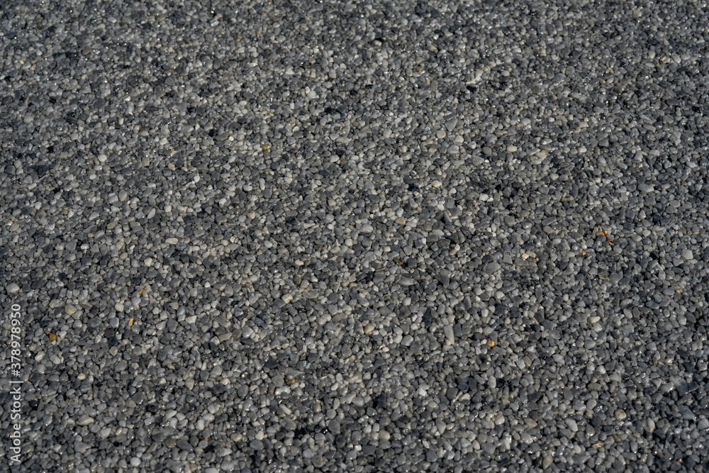 Tiny gravel texture on grey concrete wall. Texture background seamless gravel floor. Selective focus Tiny gravel texture on grey concrete wall. Texture background seamless gravel floor. Selective focus