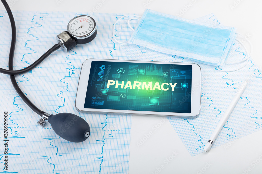 Tablet pc and medical stuff with PHARMACY inscription, prevention concept Tablet pc and medical stuff with PHARMACY inscription, prevention concept